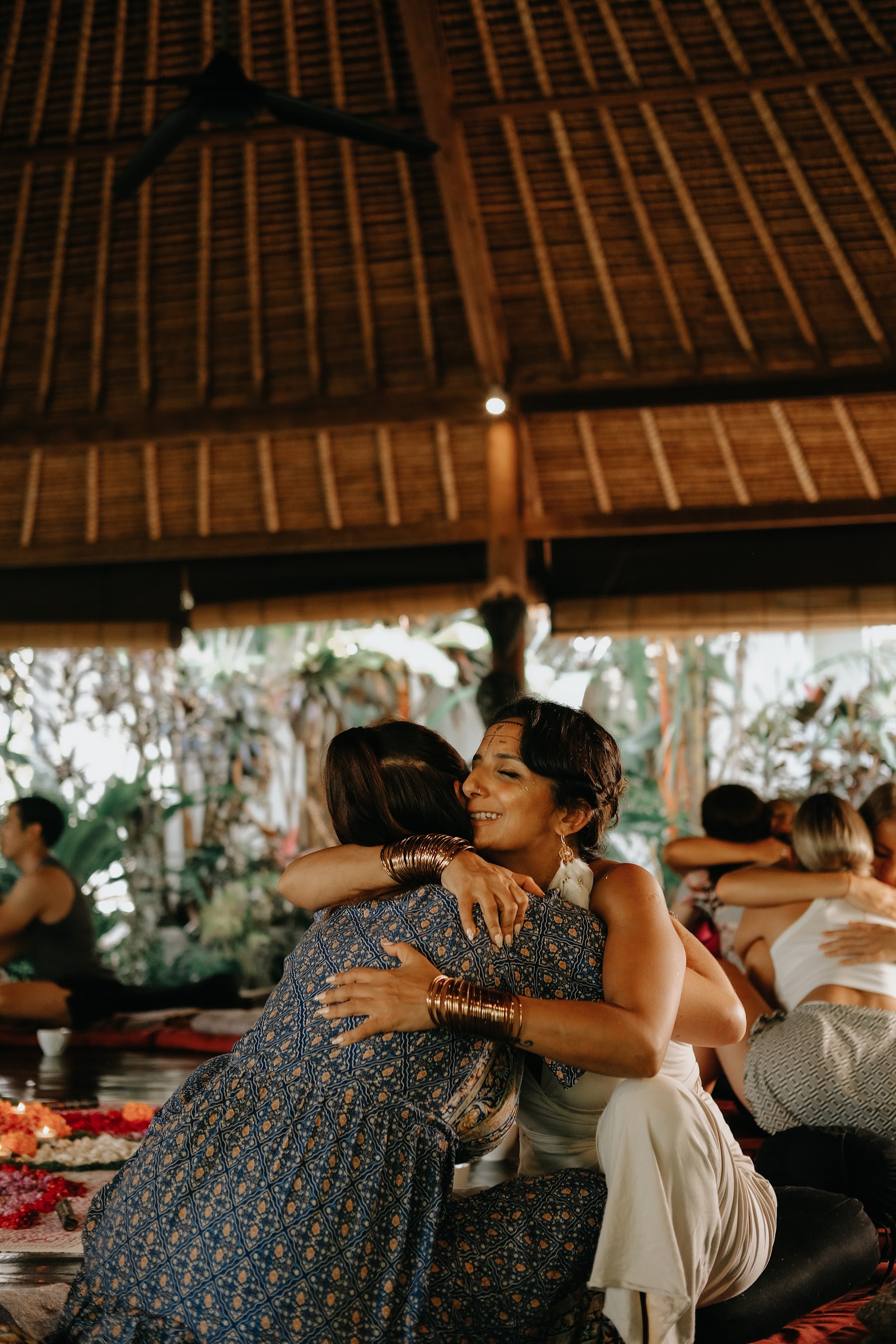 Two women in a heartfelt embrace during an InnerCamp retreat in Bali