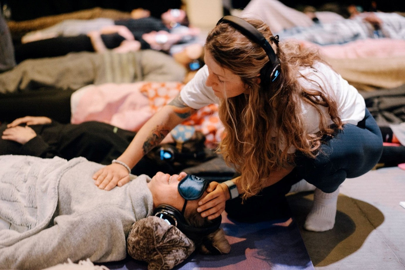 Breathwork instructor trainee assisting a client during a safe trauma-informed breathing session