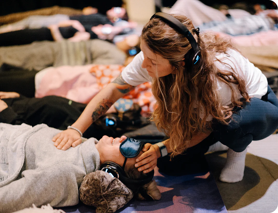 Facilitator supporting a client in a guided somatic therapy session using gentle touch, rest and nervous system awareness