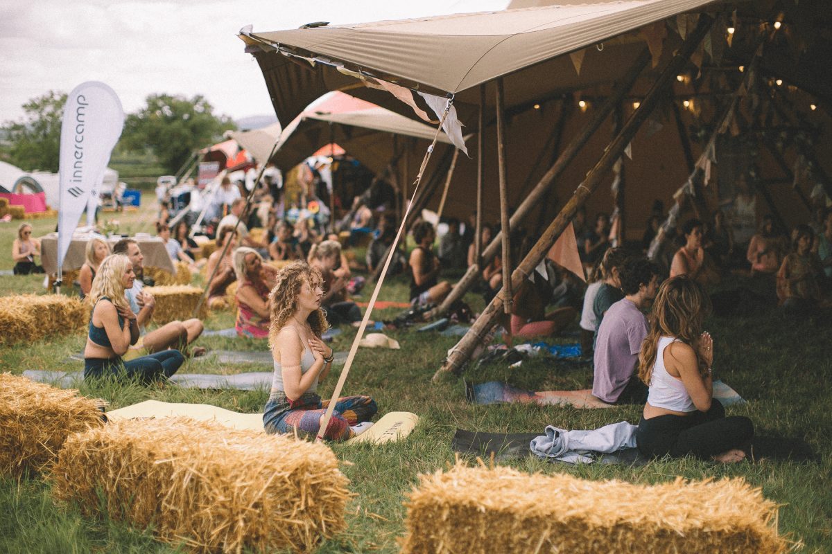 An outdoor festival breathwork session on the grass