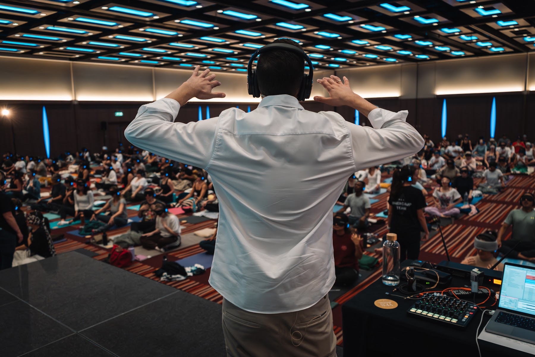 Alexis guiding a large group breathwork session