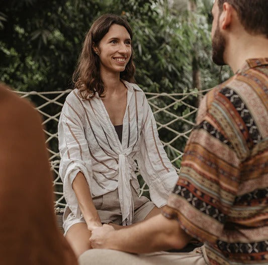 Holistic practitioner facilitating a calm, trauma-informed session that supports safety, connection, and embodied practice.